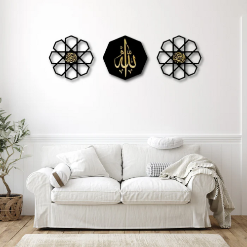 Decorative wall art pieces on a white wall above a white sofa.