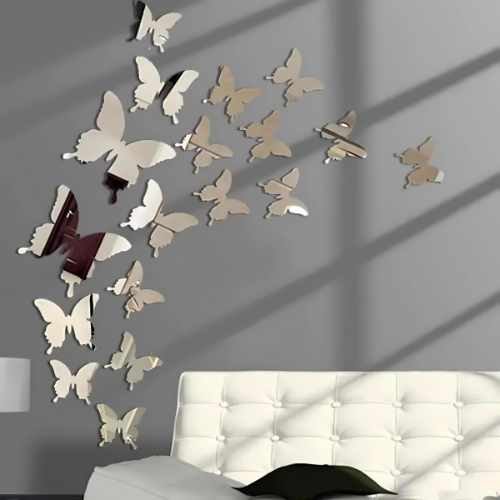 Butterfly wall decals on a gray wall with a white headboard.